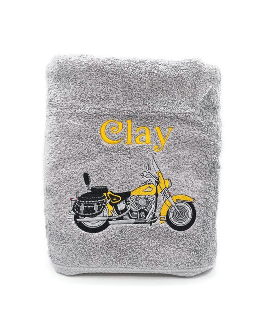 Motif moto jaune brodé sur linge de bain